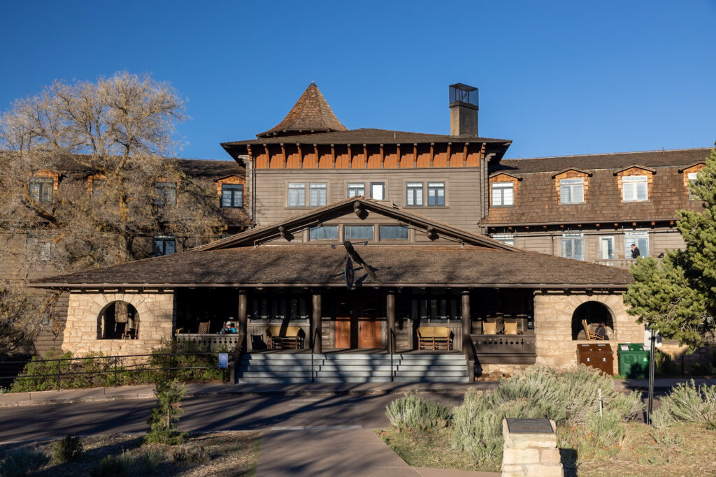 Historic El Tovar Hotel with distinctive architecture featuring a peaked roof, stone base, and covered porch entrance at Grand Canyon Village. This is one of the best things to do on the Grand Canyon South Rim.