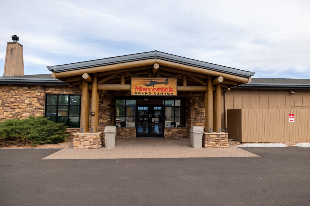 Maverick Helicopters Grand Canyon office building with stone exterior and wooden beam entrance at Grand Canyon National Park Airport