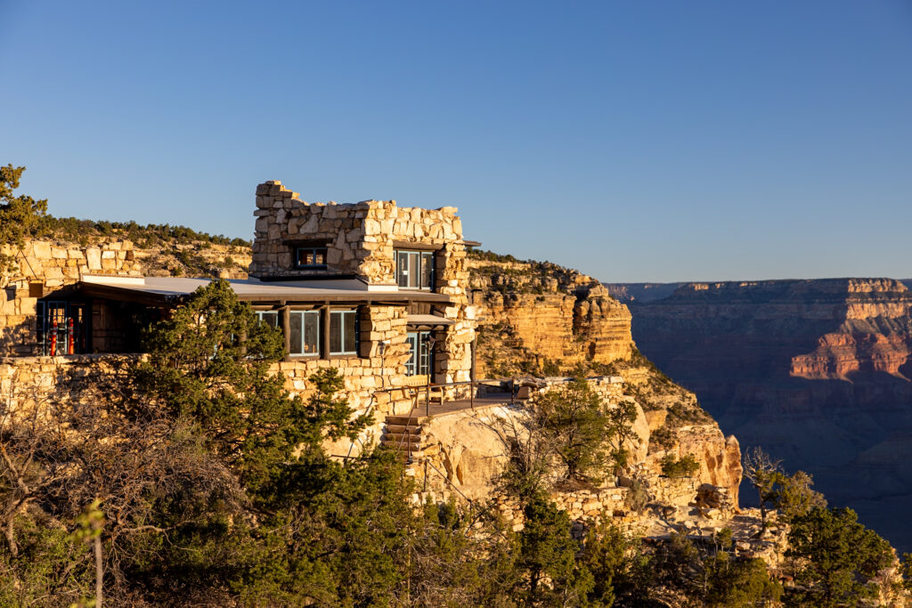 Stone structure of Lookout Studio built into the Grand Canyon rim, with canyon views visible in the background. This is one of the best things to do on the Grand Canyon South Rim.