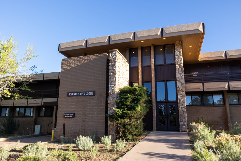 Thunderbird Lodge, a contemporary mid-century lodge with stone and brick exterior, located on the Grand Canyon rim in the historic district