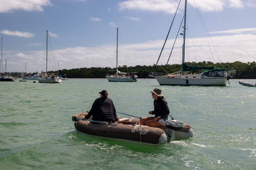 Jen and Elliott Riding the dinghy to shore for supplies, one of the least fun tasks about living on a boat.