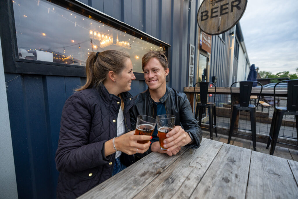 Jen and Elliot cheers at a brewery