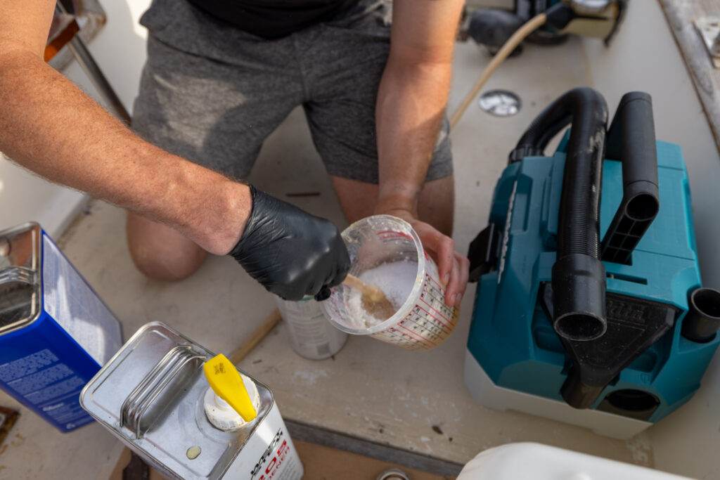 Elliot mixing epoxy next to the shop vac