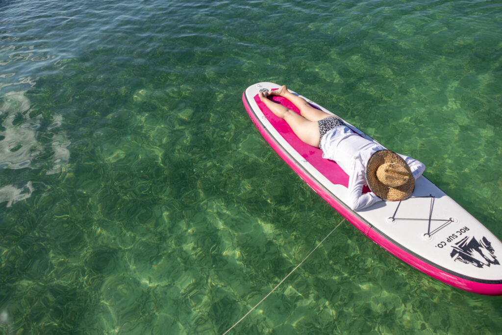 Jen Laying on a SUP, what life looks like living on a boat